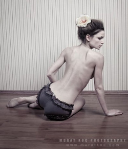 Female sitting on the ground with back to camera