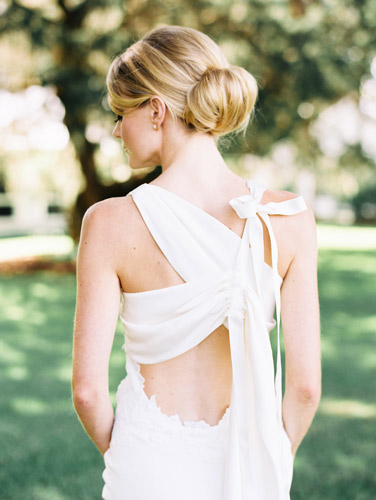 Lindsay facing away from the camera in a wedding gown showing her back