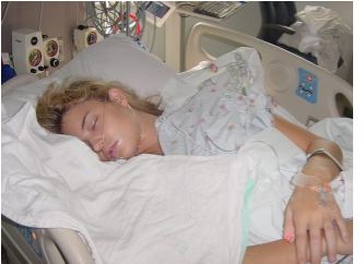 Female (Martha) sleeping in a hospital bed